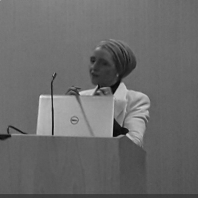 Nicola speaking at a lectern